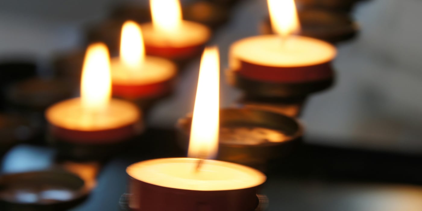 Row of burning candles